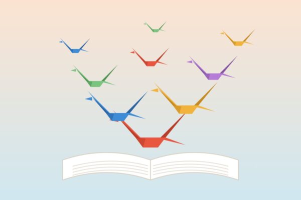 Origami ždralovi od papira lete iz otvorene knjige
